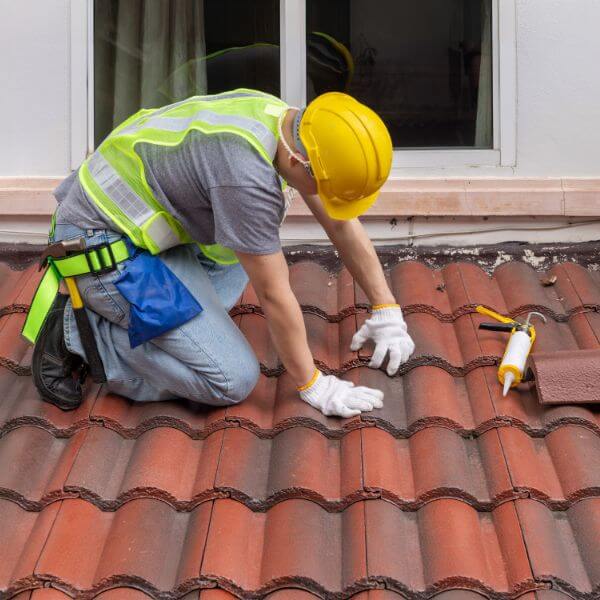 Roofer from Roofing Guys Brisbane replacing damaged roof tiles during a full tile roof replacement on a residential property. Roofer from Roofing Guys Brisbane replacing damaged roof tiles during a full tile roof replacement on a residential property.