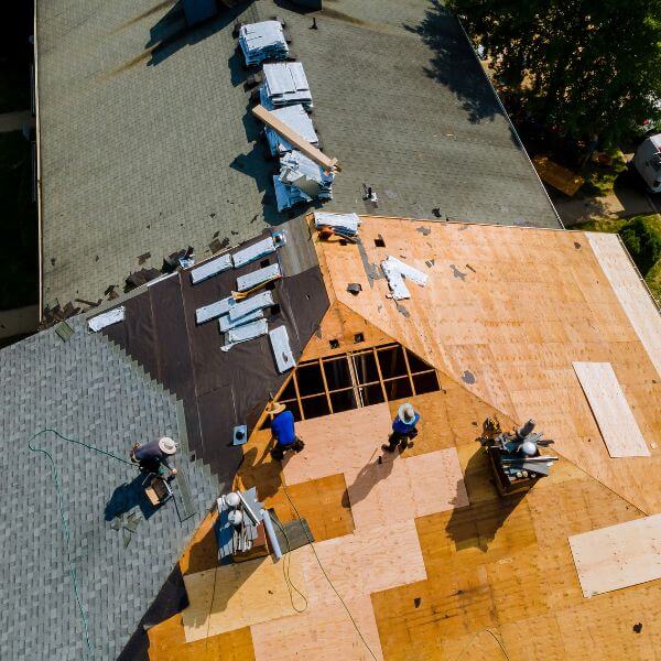 Roofing Guys Brisbane crew installing a new roof during a home renovation project, showing exposed timber sheeting and partial shingle coverage. Roofing Guys Brisbane crew installing a new roof during a home renovation project, showing exposed timber sheeting and partial shingle coverage.