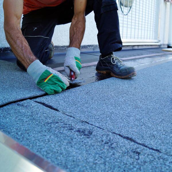 Roofing Guys Brisbane technician performing urgent commercial roof repairs using bitumen membrane on a flat roof surface in Brisbane Roofing Guys Brisbane technician performing urgent commercial roof repairs using bitumen membrane on a flat roof surface in Brisbane