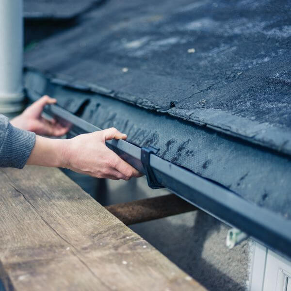 Roofing Guys Brisbane technician repairing a residential gutter to fix drainage issues and prevent water damage. Roofing Guys Brisbane technician repairing a residential gutter to fix drainage issues and prevent water damage.