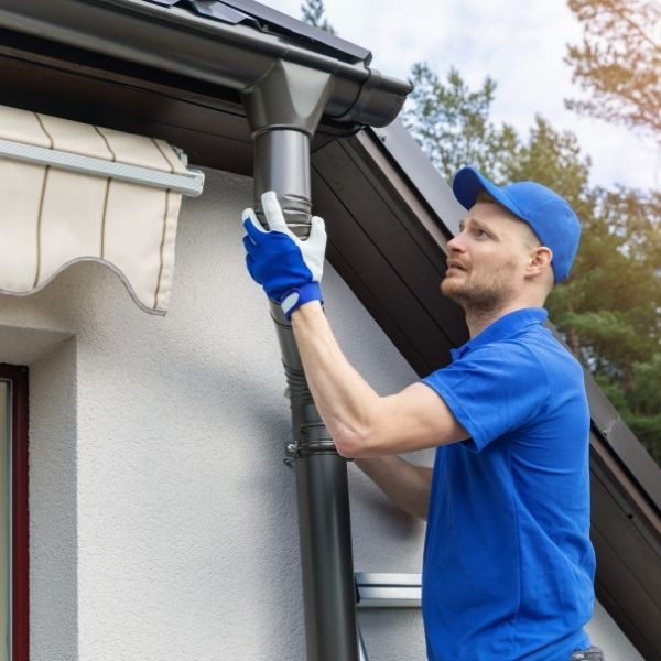 Gutter repair by Roofing Guys Brisbane fixing a downpipe to improve water flow and prevent leaks.
